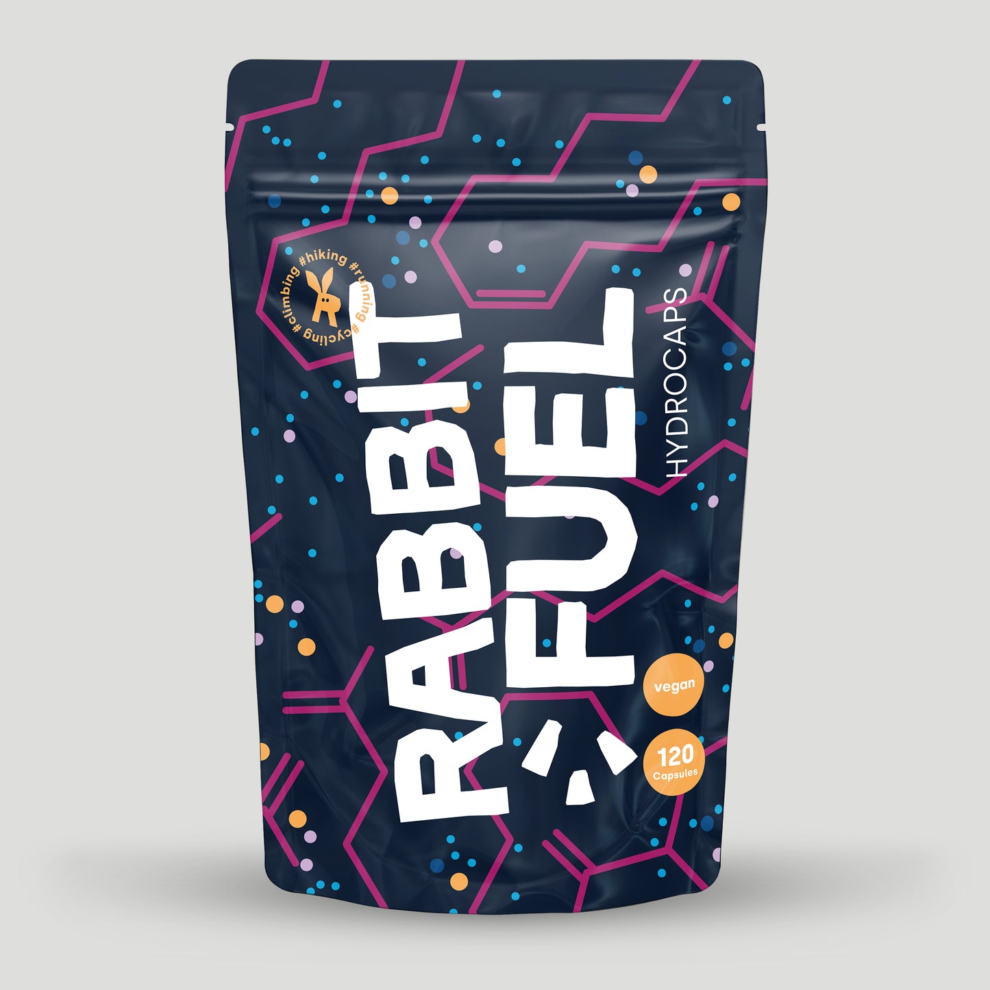 Verpackung von RabbitFuel Hydrocaps mit dunkelblauem Design, pinken und blauen grafischen Elementen sowie der Aufschrift vegan und 120 Capsules. Das Produkt ist für Outdoor-Aktivitäten wie Wandern oder Laufen gekennzeichnet.