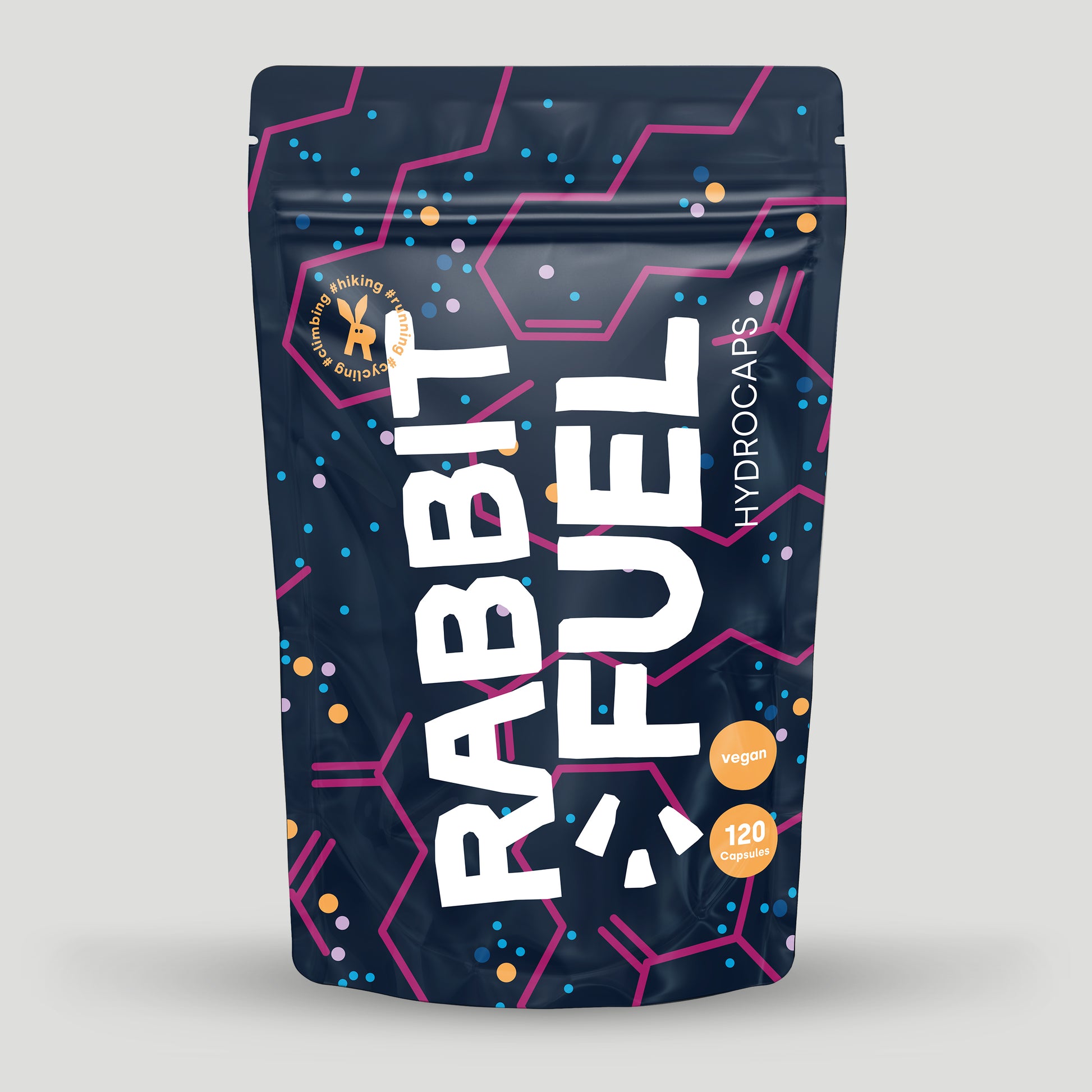 Verpackung von RabbitFuel Hydrocaps mit dunkelblauem Design, pinken und blauen grafischen Elementen sowie der Aufschrift vegan und 120 Capsules. Das Produkt ist für Outdoor-Aktivitäten wie Wandern oder Laufen gekennzeichnet.